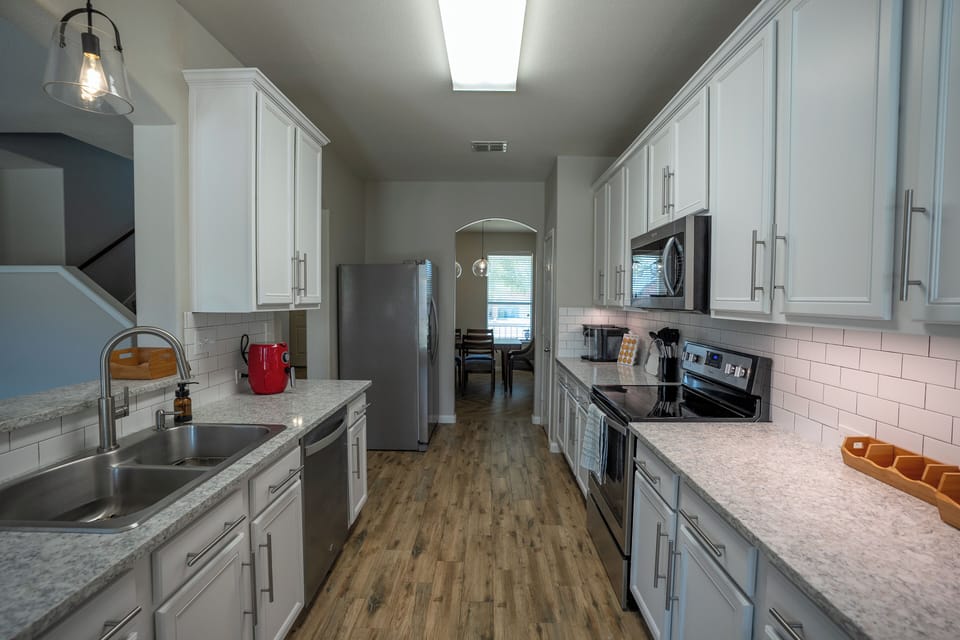 Bright modern galley kitchen with stainless appliances and ample counter space