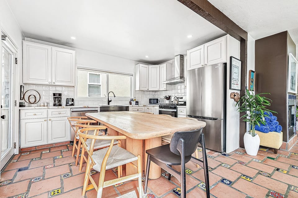 The bright kitchen opens directly to the upper deck for easy indoor-outdoor living
                