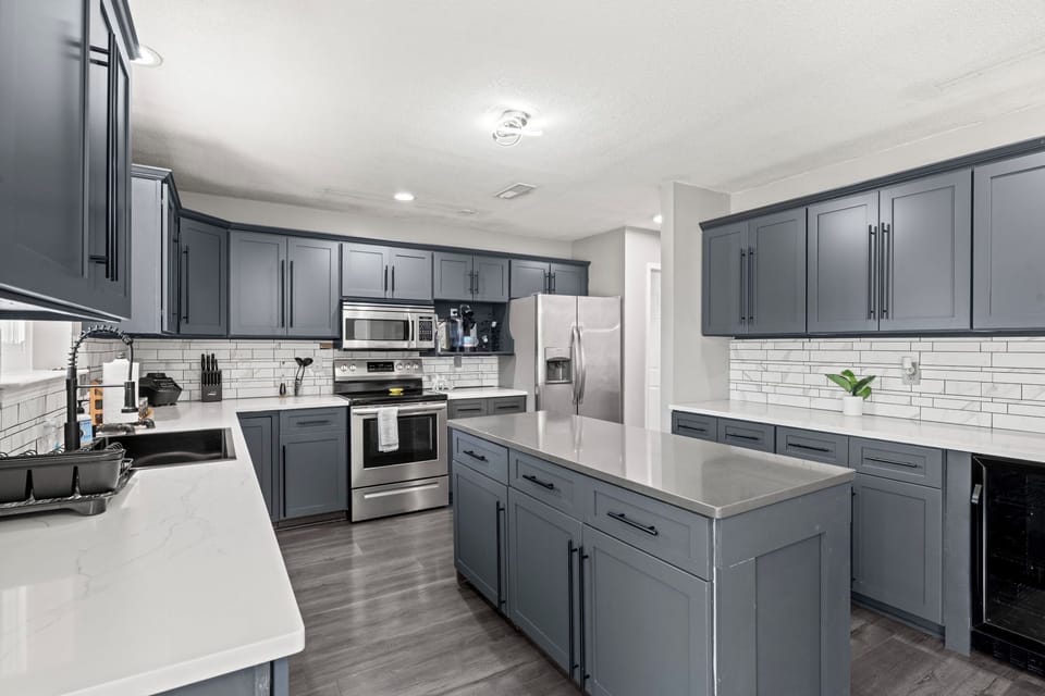 Countertops and an oversized island make this kitchen perfect for cooking together or spreading out a big meal.