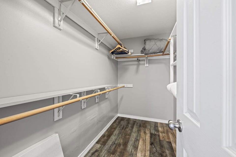 A generous walk-in closet with ample shelving and hanging space to unpack and settle in for your stay.