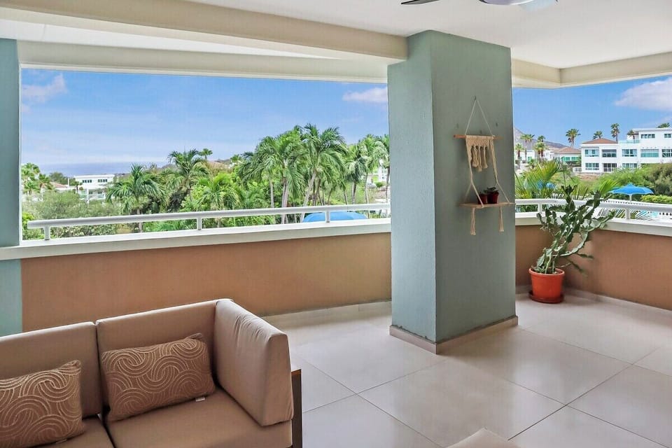 The balcony with a sea view and the view over the communal pool! Equipped with a big lounge set and a BBQ