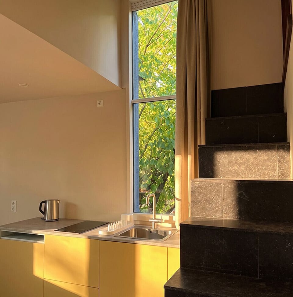 Kitchen with refrigerator, crockery and kitchen utensils