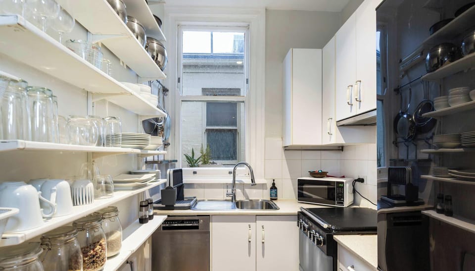 Galley style kitchen with dishwasher and microwave.