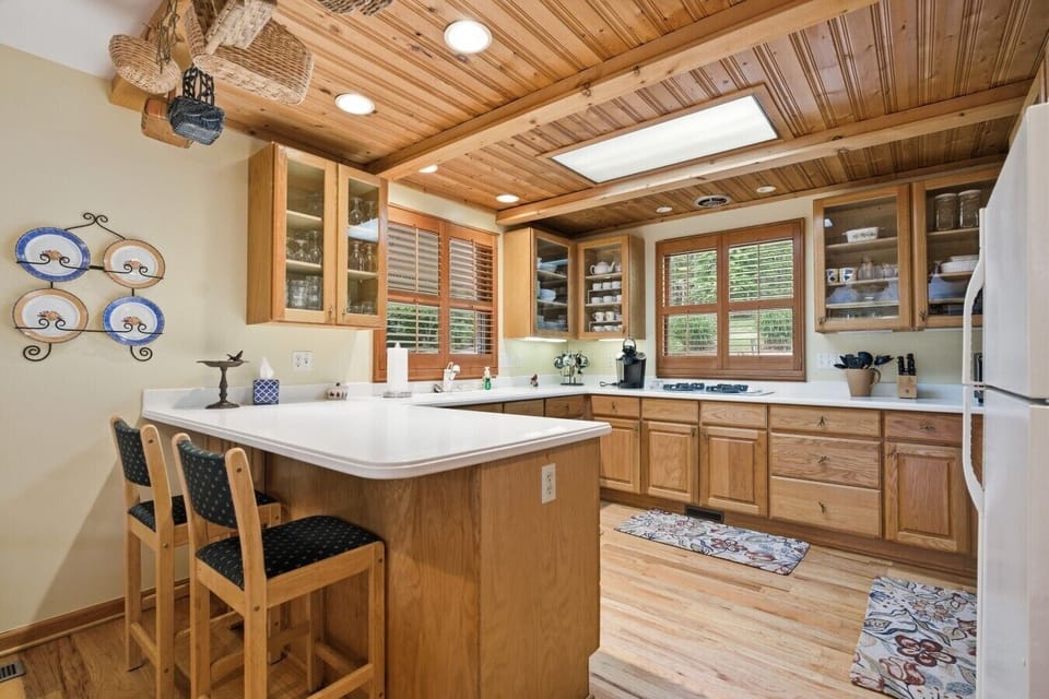 Kitchen | Breakfast Bar Seating & Wood Cabinetry | Plank Ceiling