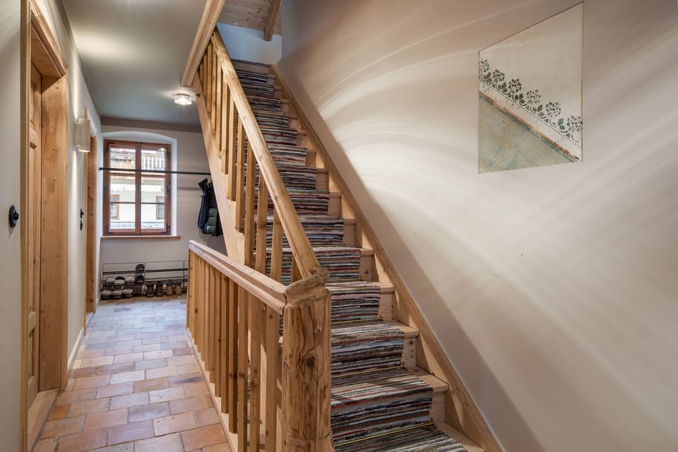 Book a chalet in Aschau near Kirchberg with stylish staircase, high-quality wood design and a traditional-modern renovated interior.