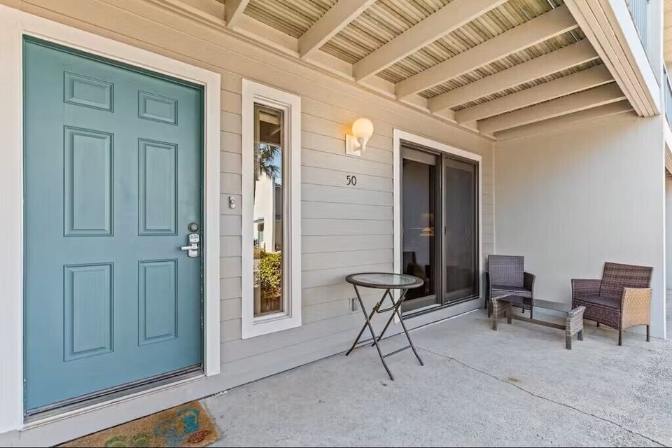 Welcoming private entrance with covered porch seating