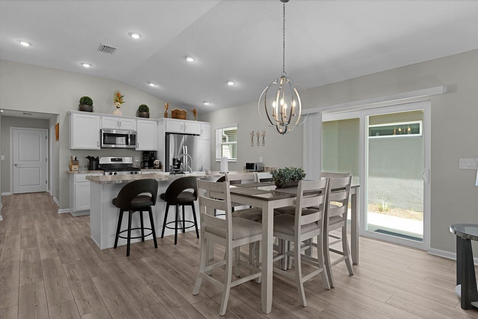 Gather your group around the spacious kitchen island or the high-top dining table, where bright natural light and modern finishes create a welcoming space for cooking and connecting together.