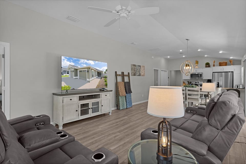 Settle into plush recliners and feel at home in this spacious open-concept living area, where high ceilings and soft lighting create a welcoming retreat after your adventures.