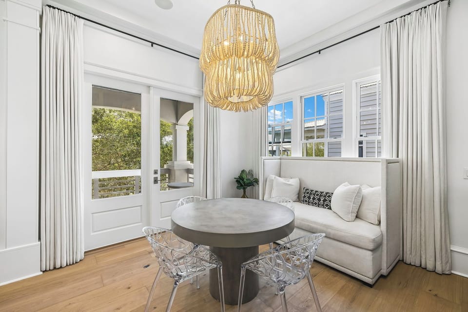 Sink into your cozy corner banquette while natural light pours through the windows, casting a warm glow over your intimate dining table for two.