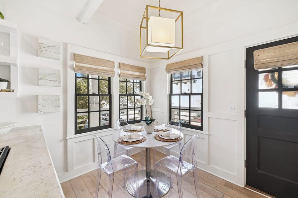 Your bright breakfast nook beckons with natural light streaming through charming windows, perfect for morning coffee and intimate meals.