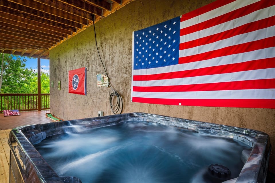 Soak until you've completely forgotten what day it is — the private hot tub glows blue, the jets work hard, and this corner of the cabin is tough to leave.