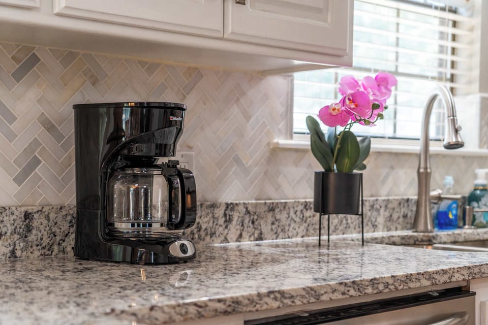 There is a drip coffee maker. Filters and coffee grounds are provided.