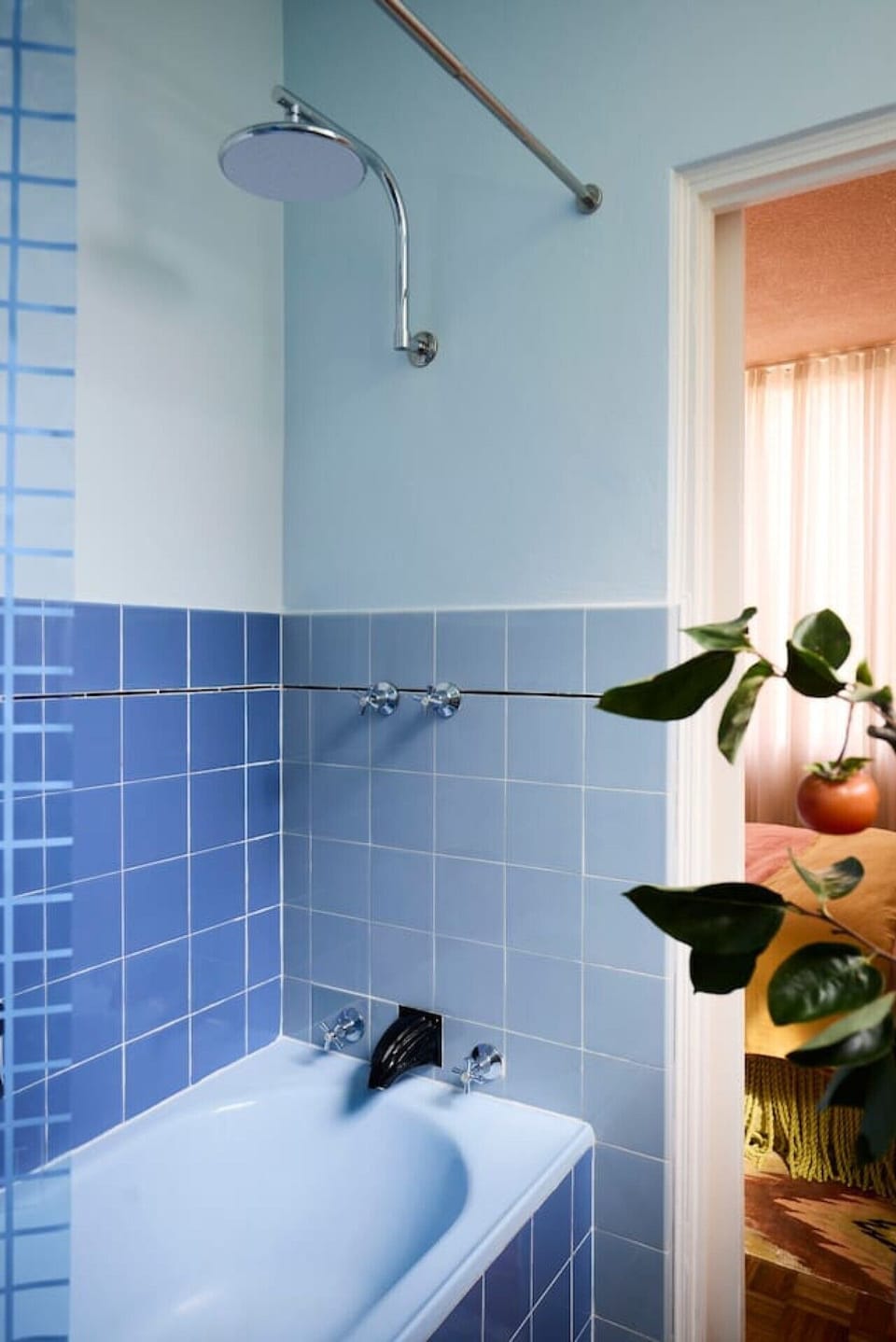 Freshen up after the beach with a shower or relaxing soak in the character-filled blue-tiled bathroom
