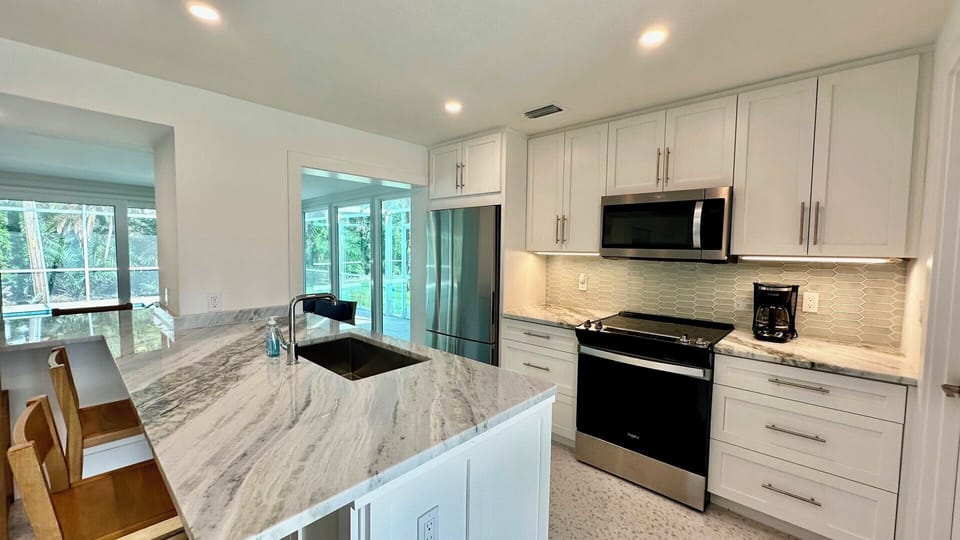 Fully-equipped kitchen; quartz countertops.
