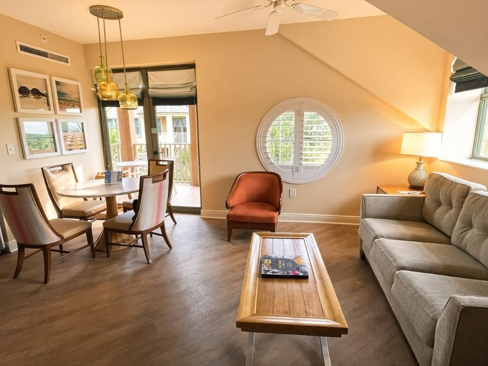 Living Area • Sofa, Round Window & Balcony Access