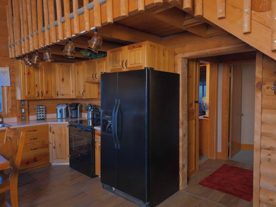 Cozy cabin kitchen with full-size appliances and rustic wood charm