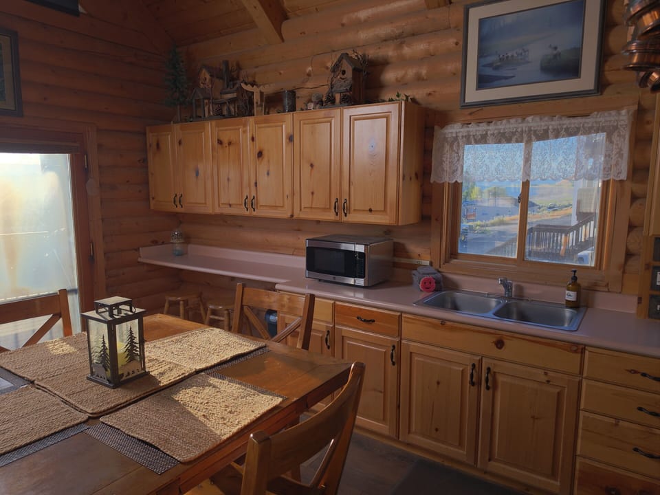 Cozy log cabin kitchen with dining space and charming rustic details