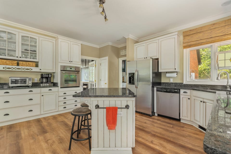 Large kitchen with plenty of plates and cooking supplies 