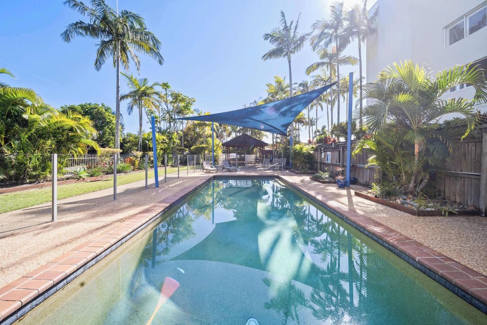 Shared swimming pool offering a refreshing place to relax during your coastal getaway