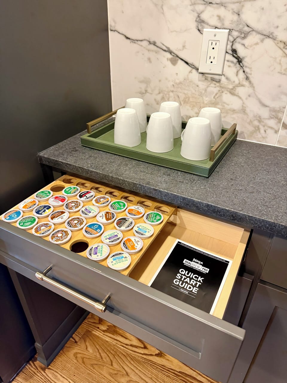 Convenient in-room coffee station with mugs, pods, and stylish finishes