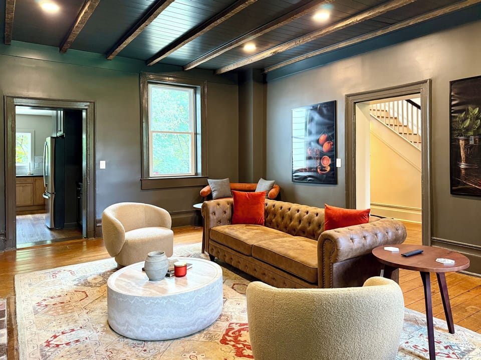 Elegant living room with leather sofa, marble table, and rich designer details
