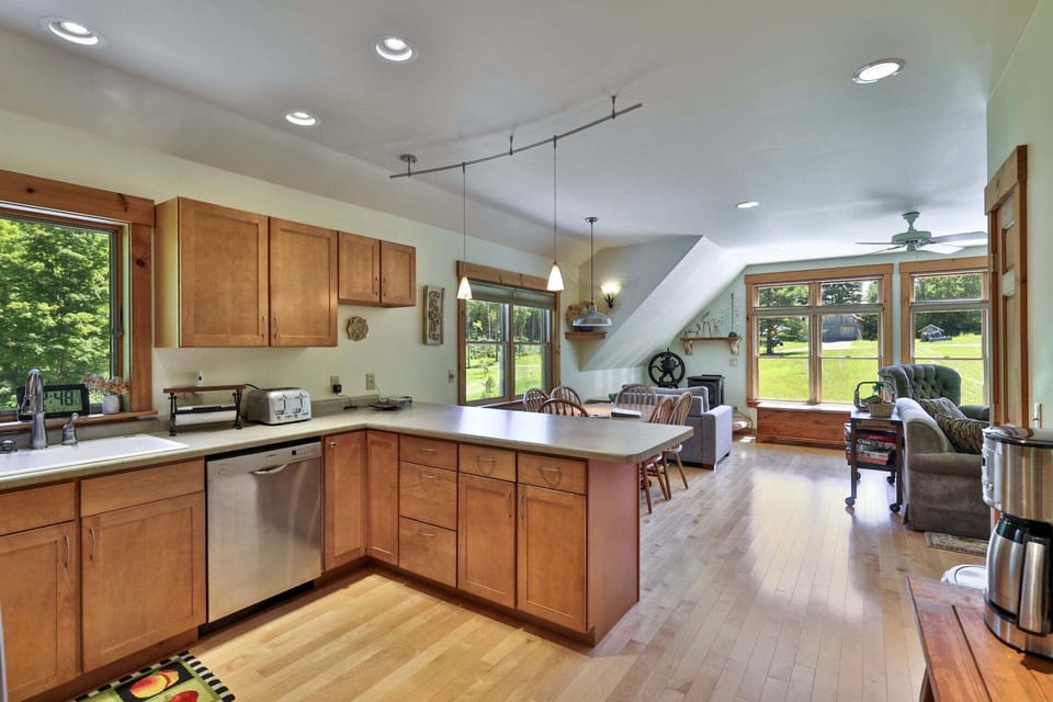 Cook together in a full kitchen that opens directly to the dining and living areas.