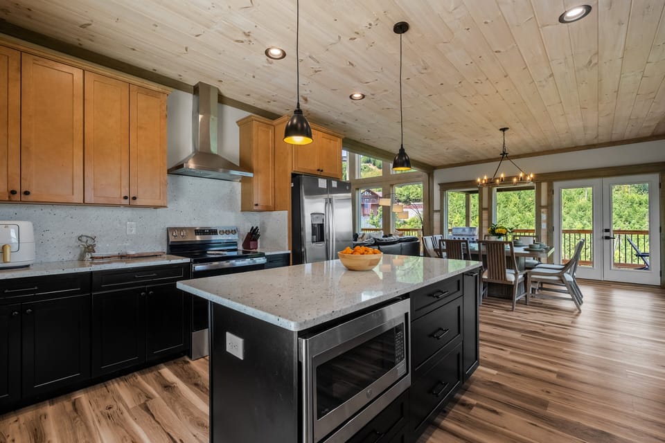 Spacious kitchen with a large center island, modern appliances, ample cabinetry, and open access to the dining area.
