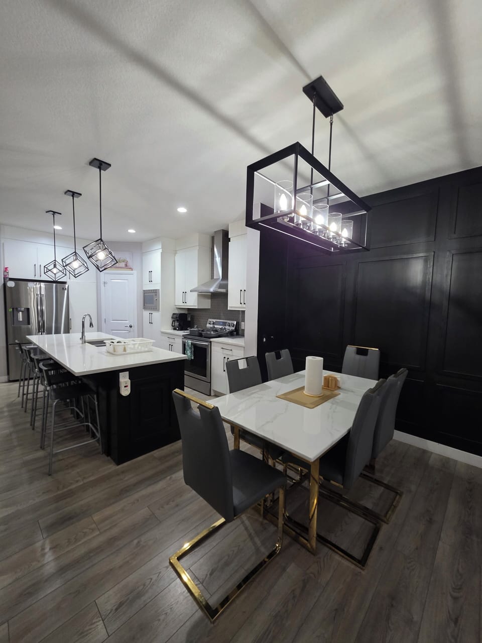 kitchen visible, indoor dining, indoor, coffee maker, oven, refrigerator, stovetop, kitchen island with seating.