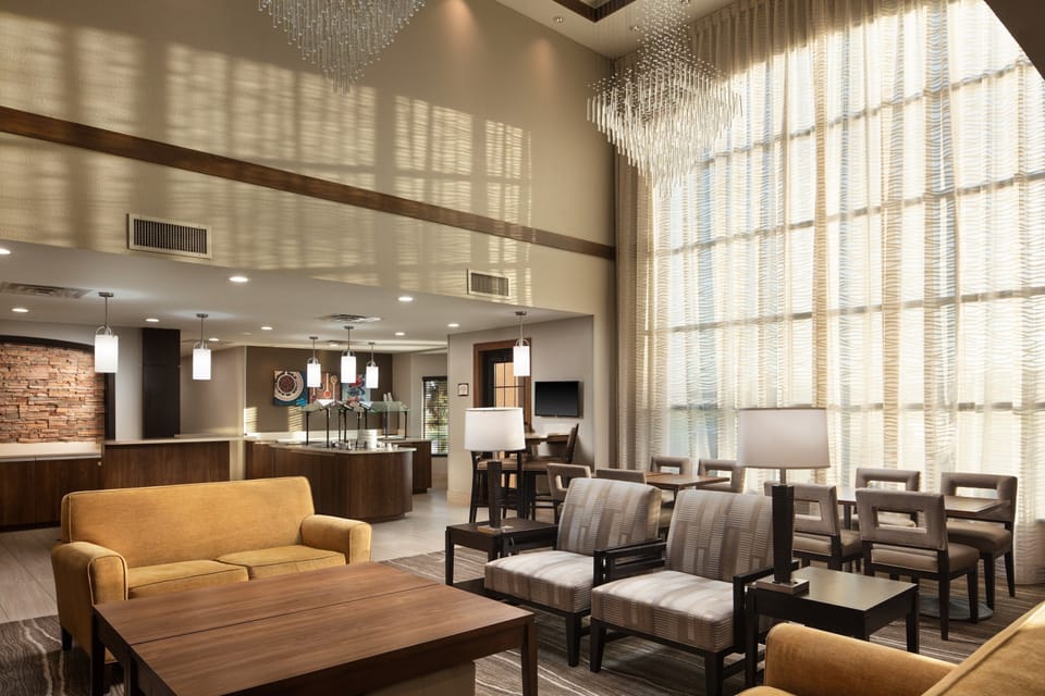 Bright common area with comfortable seating and large windows.