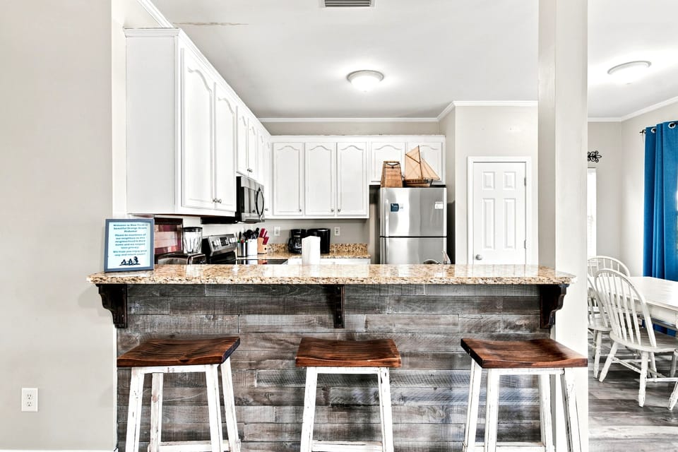 The fully equipped kitchen makes it easy to cook fresh Gulf seafood or a quick breakfast, with bar seating for casual meals.