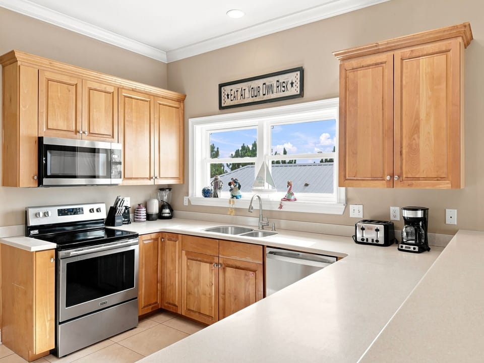 Fully equipped kitchen with stainless steel appliances and generous counter space