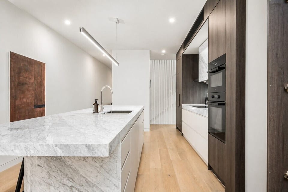Integrated appliances and abundant storage keep the kitchen beautifully streamlined