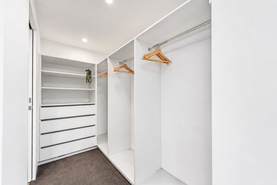 An expansive walk-in wardrobe with generous hanging space, shelving and drawers