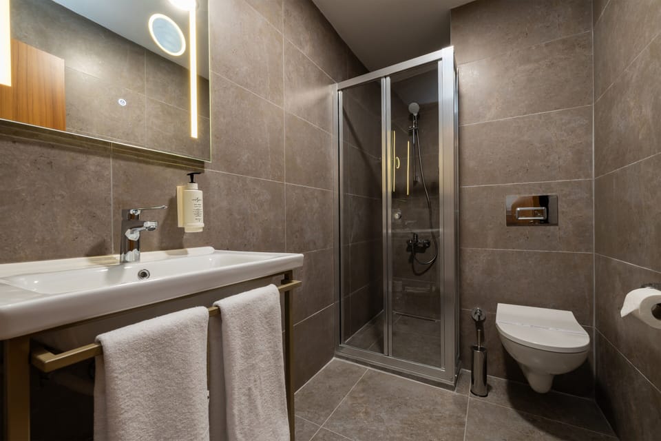 Shower, hair dryer, slippers, towels