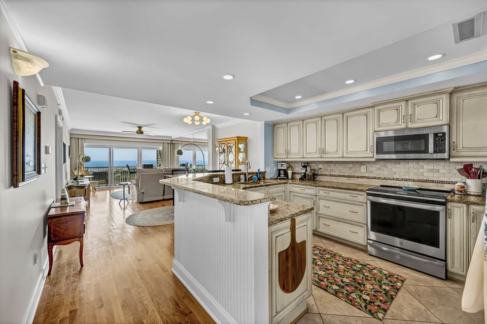 Prepare your favorite meals in this spacious gourmet kitchen with granite countertops, modern appliances, and a breathtaking ocean view that stretches beyond your living space.