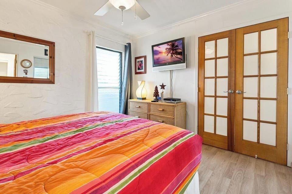 Bright and welcoming, your bedroom features a comfortable bed, ceiling fan, and plenty of natural light streaming through the window—your perfect spot to unwind after a day of exploring.
