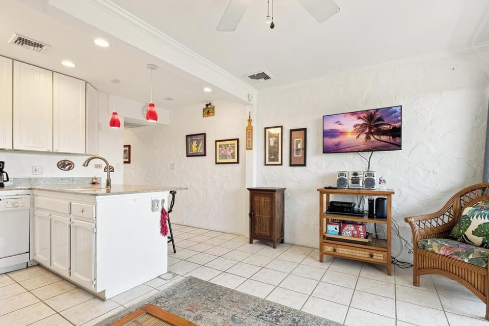 Step into this bright, open-concept retreat where kitchen and living space flow together seamlessly. Cheerful tropical touches and comfortable furnishings invite you to unwind after your island adventures.