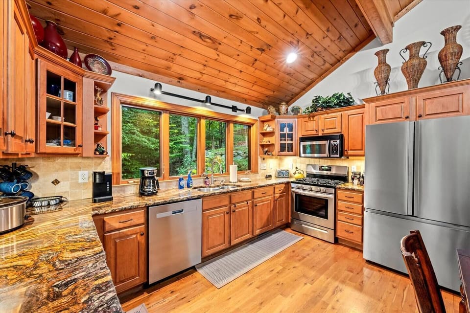 [Kitchen/dining area] Includes a large refrigerator, a microwave, an oven range, and a dishwasher.