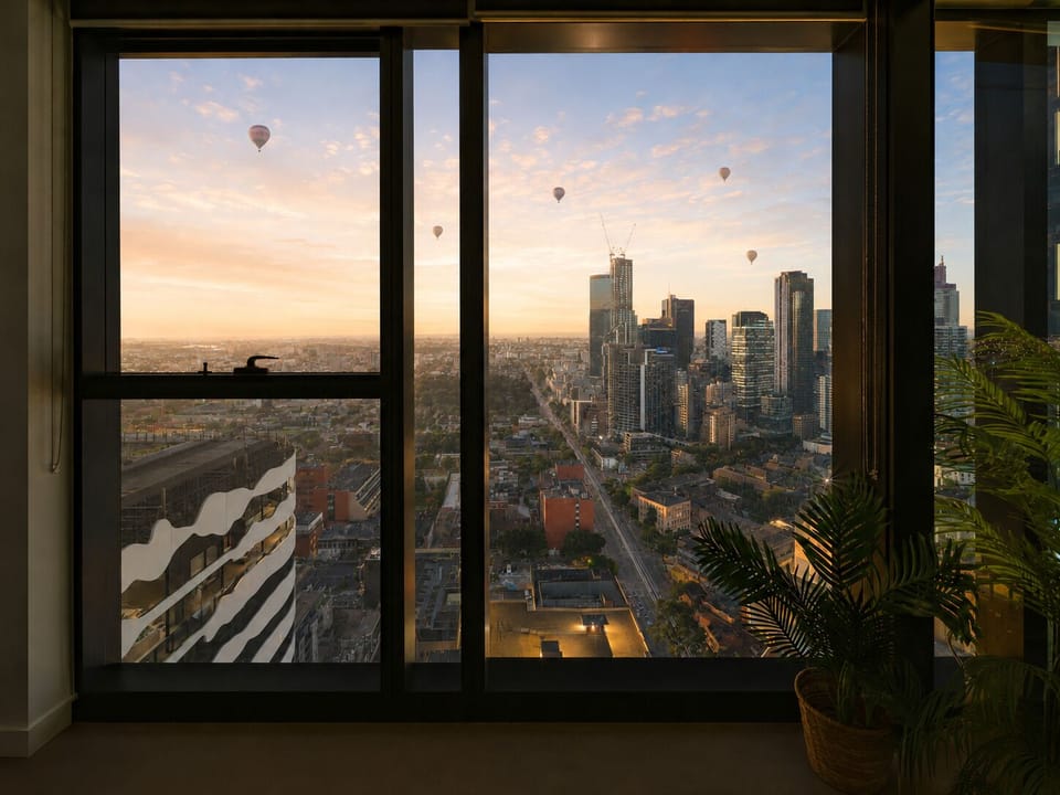 Floor-to-ceiling windows with stunning skyline and hot air balloon views