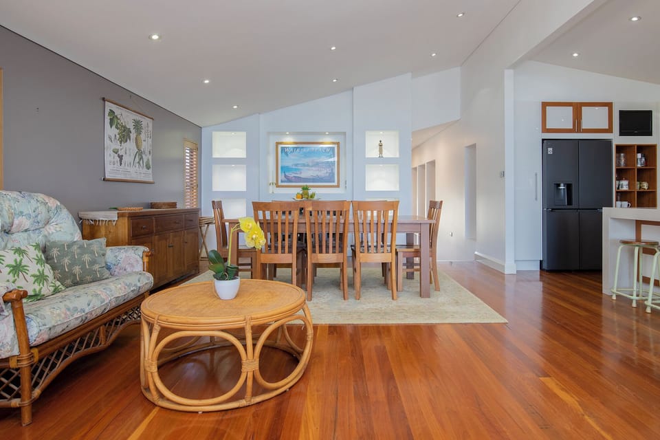 Gather around the timber dining table, perfectly positioned beside the kitchen for everything from leisurely breakfasts to celebratory dinners together.