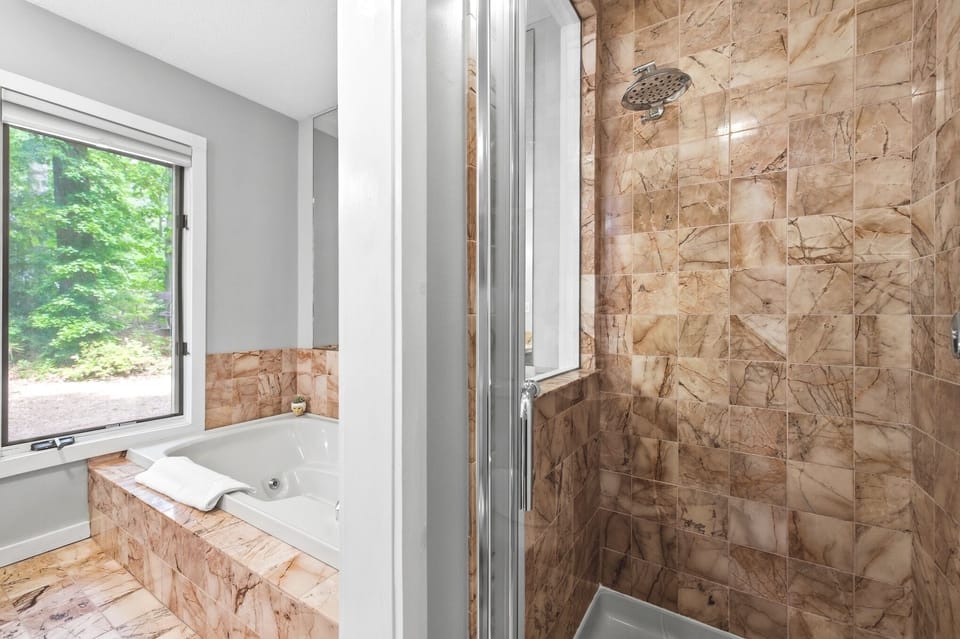 Primary ensuite with a jetted tub and walk-in shower.