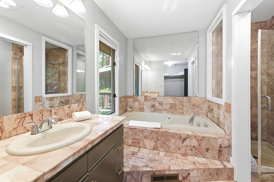 Relax in the primary ensuite bathroom featuring a soaking tub.
