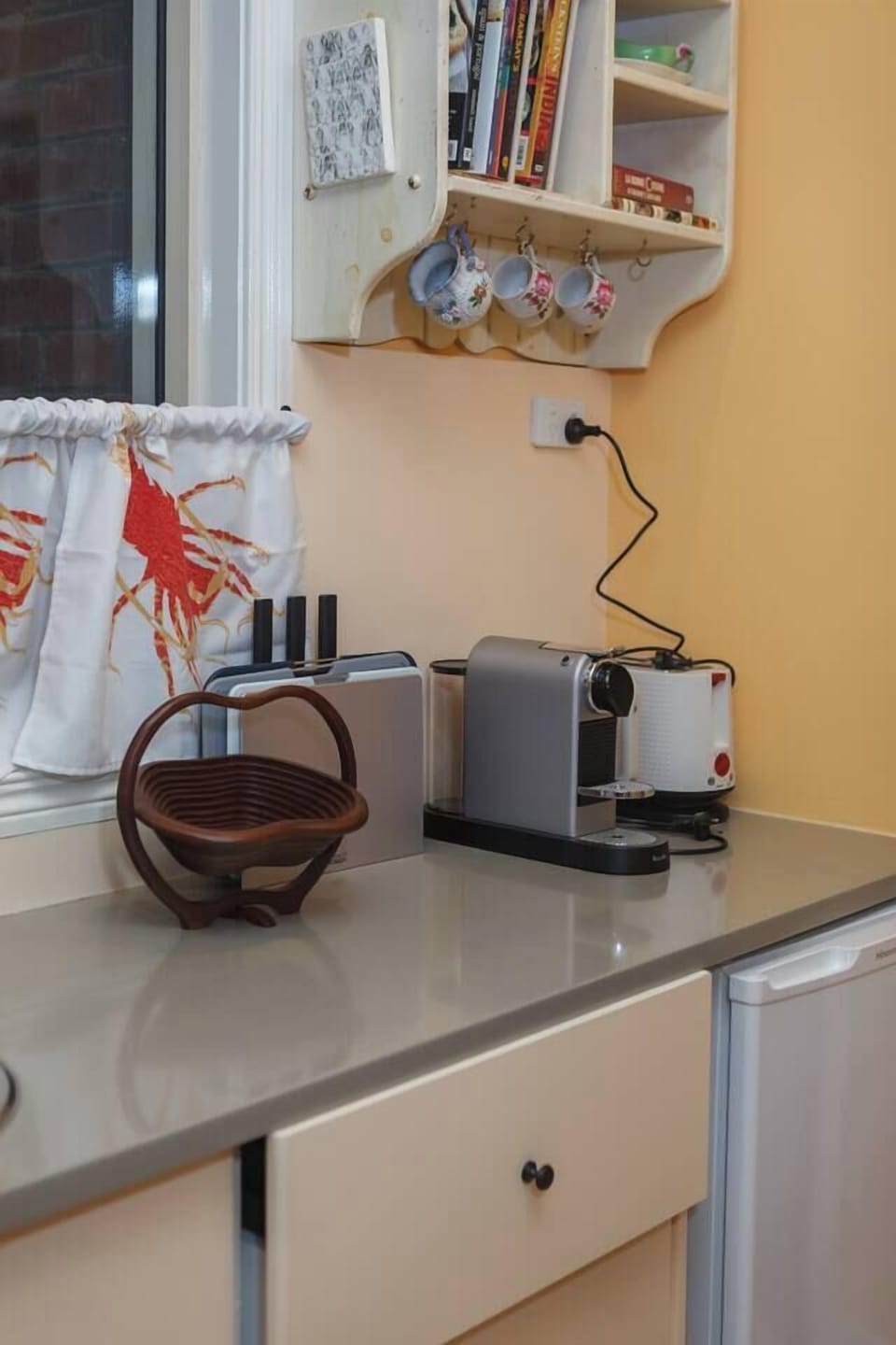 Enjoy your morning brew at the coffee station, complete with a Nespresso machine, hanging teacups, cookbooks, and open shelving that adds convenience to your start of day.
