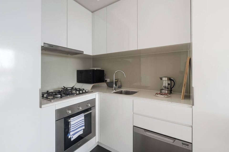 Prepare easy meals in the compact kitchen, where essential appliances and a streamlined layout keep everything within reach.