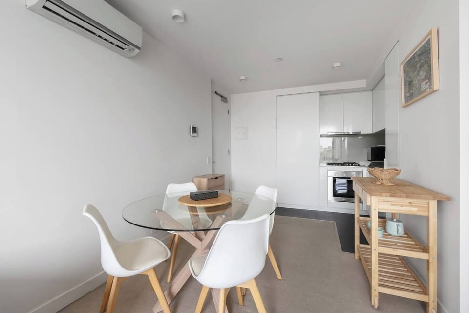 Share a meal at the round dining table, where a simple setting invites casual breakfasts or relaxed dinners.