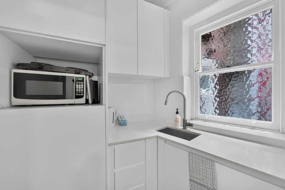 Prepare simple breakfasts in the kitchenette, equipped with a stovetop, microwave, refrigerator, kettle and everyday cooking essentials.