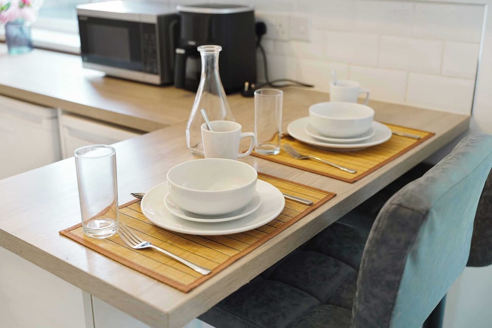 A functional kitchen offering everything needed for everyday cooking, including an electric hob, oven, fridge/freezer, microwave, kettle and toaster. Essential cookware and laundry facilities are also available.