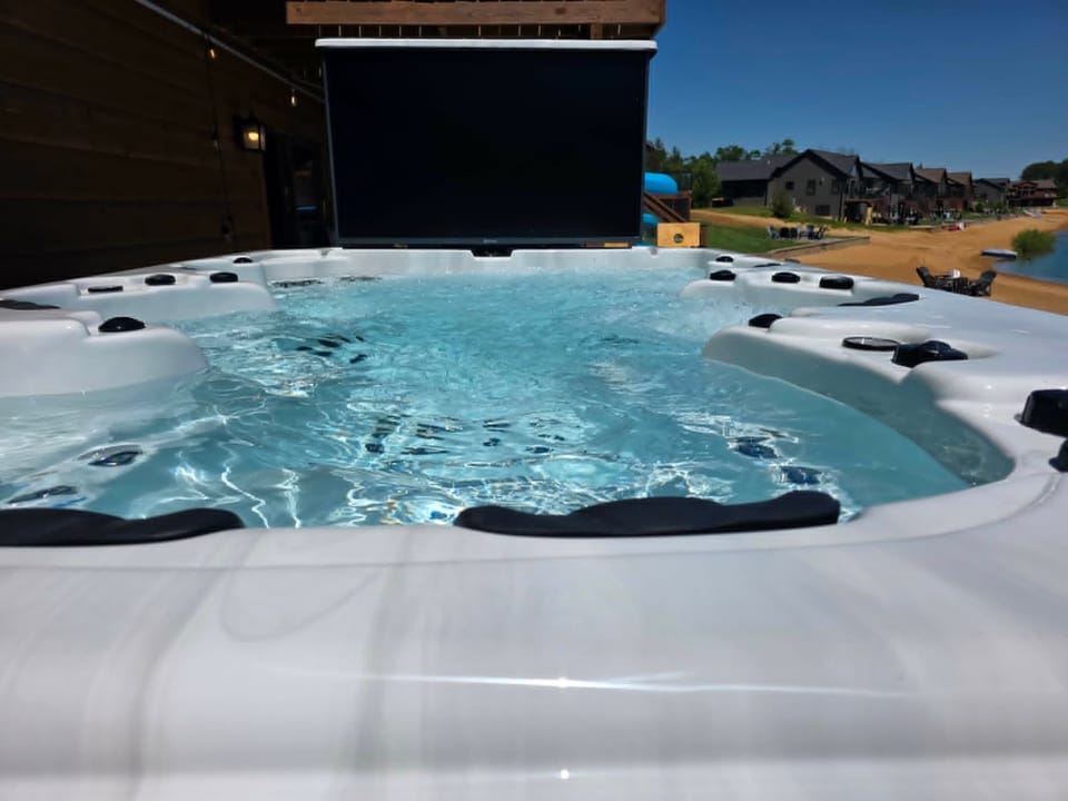 Six-person hot tub with a scenic view of the lake.