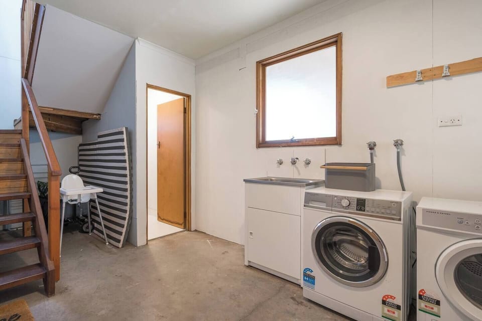 Keep things fresh with a downstairs laundry featuring a washer, dryer and sink—conveniently tucked away for longer stays.
