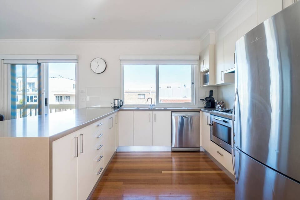 Prepare delicious meals in the fully equipped kitchen featuring a gas cooktop, oven, dishwasher, microwave and full-sized fridge, plus all the essentials from cutlery to cookware.
